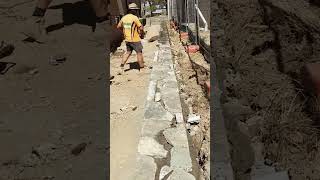 Sealing the top of this recycled concrete retaining wall with a dyed mortar shorts construction [upl. by Auguste]