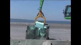 SENNEBOGEN  Material Handling 850 Mobile Material Handler loading waste bales from ship to truck [upl. by Quinby175]