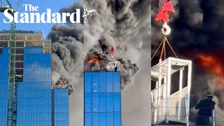 Watch Dramatic moment man winched to safety after huge blaze breaks out in Reading [upl. by Fitalludba]