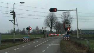 Dutch railroad crossing at Sevenumthe NetherlandsDecember 32008 and intercity train passing [upl. by Macey]